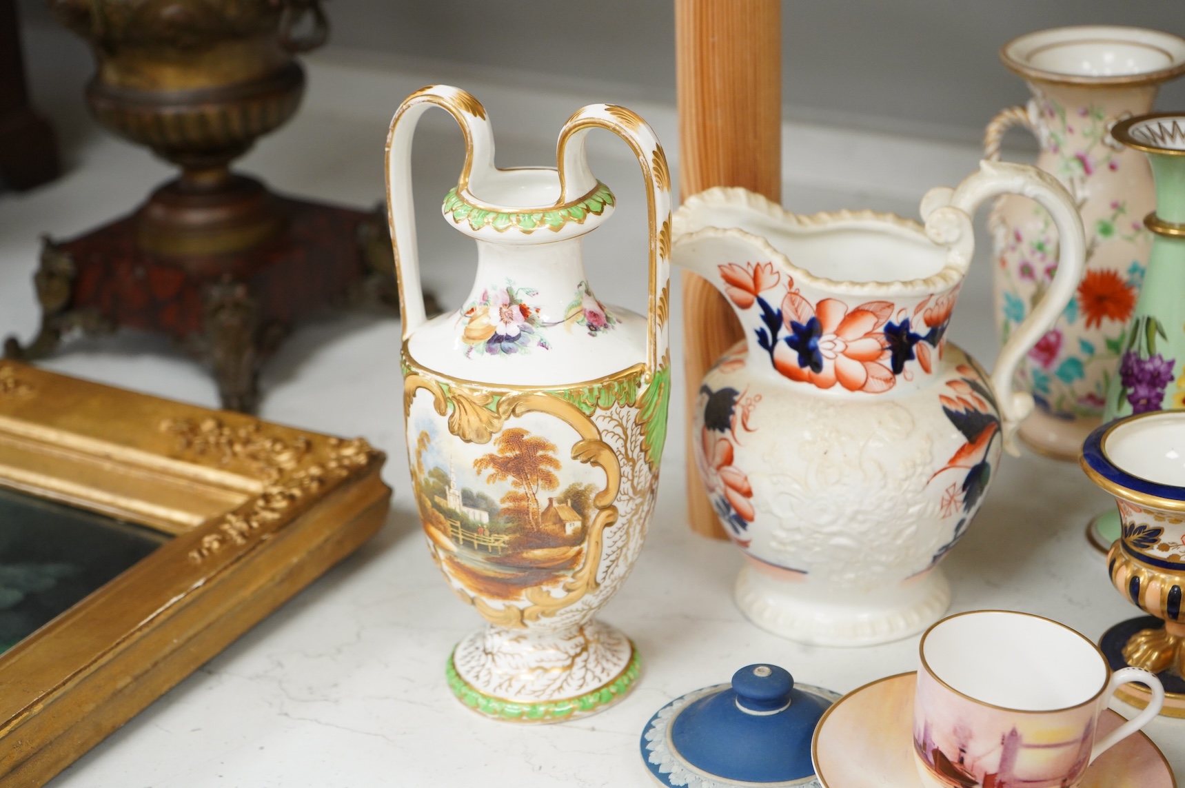 Large group of 19th/20th century English ceramics, to include a Rockingham basket, other English porcelain flower encrusted vessels, a Copeland and Garrett ewer, a Minton Sevres style beaker, a Wedgwood agate ware jug, R